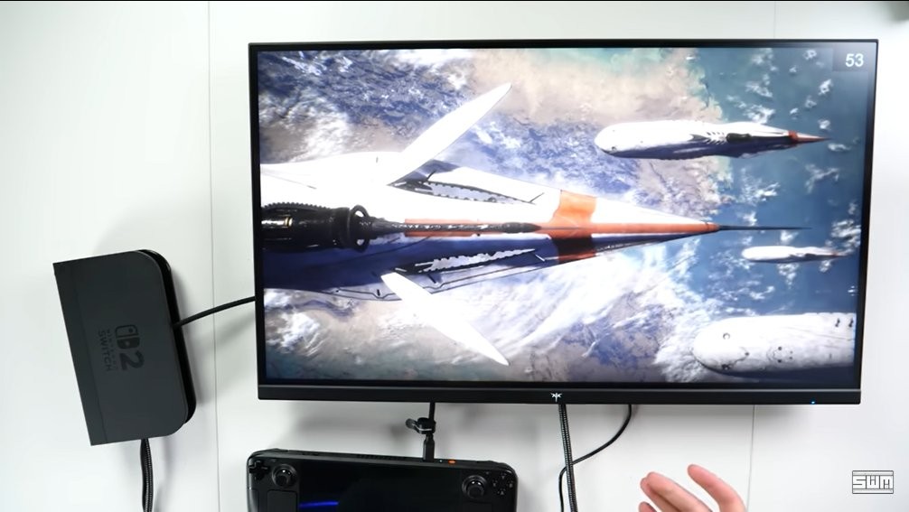 实测场景俯拍图：Switch 2底座置于桌面中央，HDMI线连接4K显示器，屏幕正显示Steam Deck桌面环境，右下角弹出系统级VRR状态提示窗口